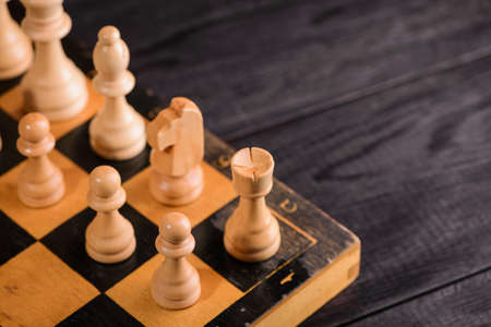wood chess pieces on board game. brown vintage backgroundの写真素材