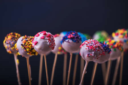 colored sweet cake pops candy on blue backgroundの写真素材