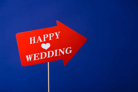 Photo booth for ceremony. Red pointer or arrow on wedding blue backgroundの写真素材