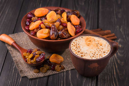 aroma coffee cup with dried fruit on wood backgroundの写真素材