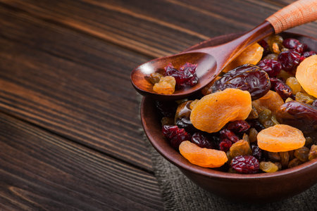 Mix of dried fruit in clay bowl. healthy food backgroundの写真素材