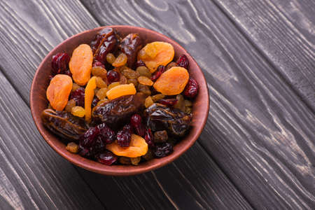 Mix of dried fruit in clay bowl. healthy food backgroundの写真素材