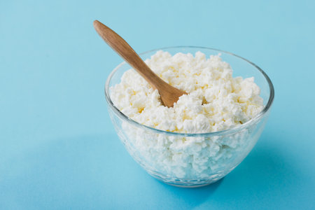 Fresh cottage cheese in a glass bowl. Diet background. healthy food