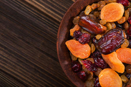 Mix of dried fruit in clay bowl. healthy food backgroundの写真素材