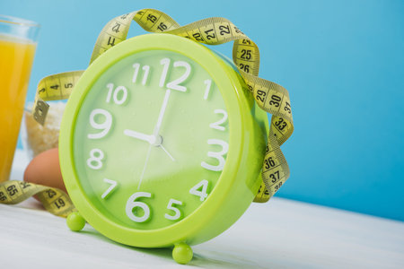 close up of green clock, diet concept background