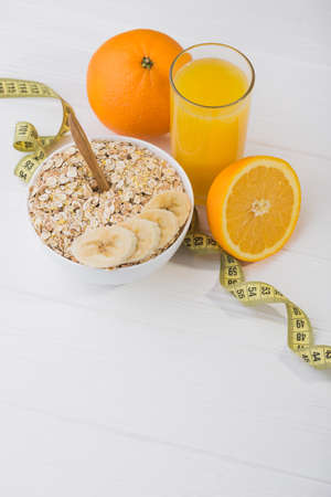 healthy breakfast of oatmeal and a glass of fresh orange juiceの写真素材