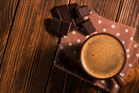 coffee cup with chocolate bar on napkin. rustic ventage style tableの写真素材