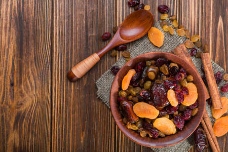 Mix of dried fruit in clay bowl. healthy food backgroundの写真素材