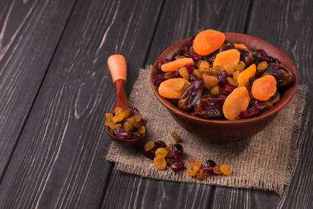 Mix of dried fruit in clay bowl. healthy food backgroundの写真素材