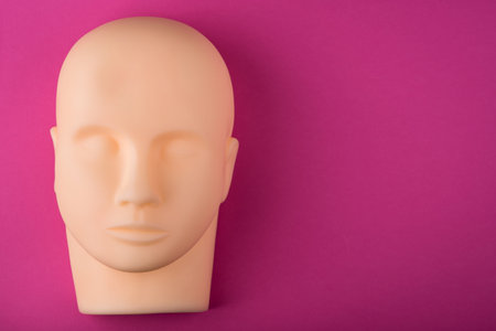 empty human mannequin head with realistic skin on texture. top view