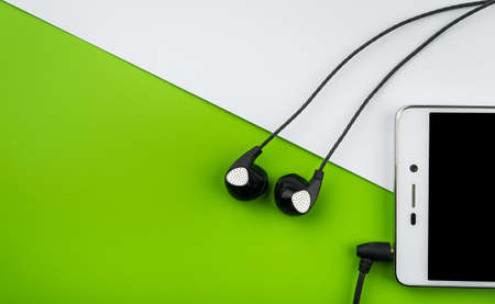 Headphones and smartphone mobile device on color backgroundの写真素材