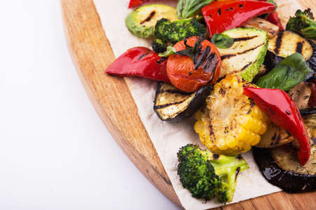 Grilled vegetables on cutting board isolated on white backgroundの写真素材