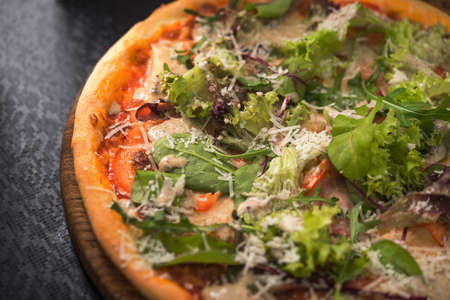 natural fresh pizza with salad on black tableの写真素材