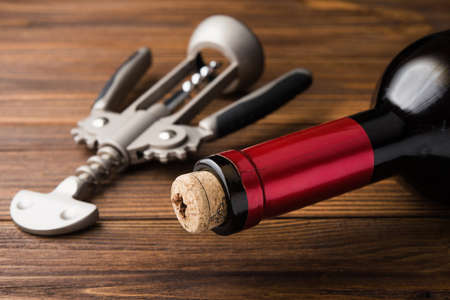wine corkscrew and bottle on wooden table. alcohol backgroundの写真素材