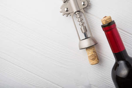 wine corkscrew and bottle on wooden table. alcohol backgroundの写真素材