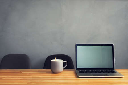 coffee cup and laptop in office table. modern workplace studioの写真素材
