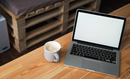 coffee cup and laptop in office table. modern workplace studioの写真素材