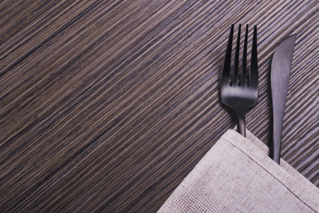 knife and fork on wooden table.cutlery on background