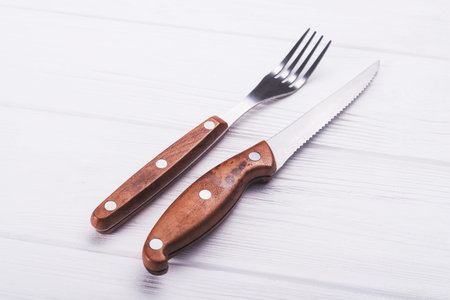 knife and fork on wooden table.cutlery on background