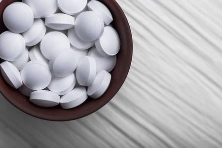 Closeup of medical pills on white table