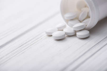 Closeup of medical pills on white tableの写真素材