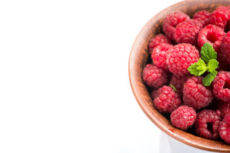 Sweet dessert, ripe raspberry on bowl isolated on white background