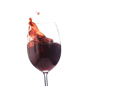 Red wine glass with splash isolated on white backgroundの写真素材