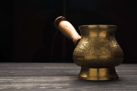 Hot turkish coffee pot on wooden table. aroma drink beverageの写真素材
