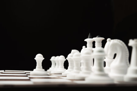 chess pieces on the board, black background 