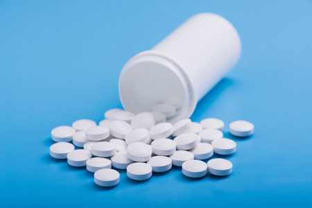 White medical pills on a blue background
