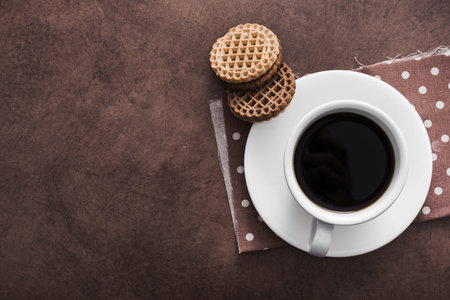 white cup of coffee with chocolate cookies on vintage concrete background, top viewの写真素材