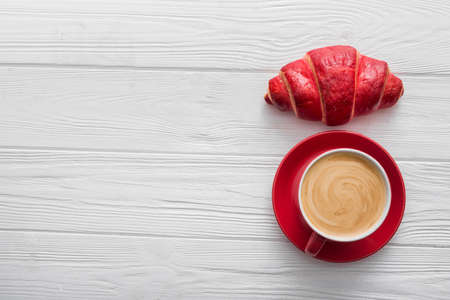 aroma coffee cup with croissant on a wood table, top viewの写真素材