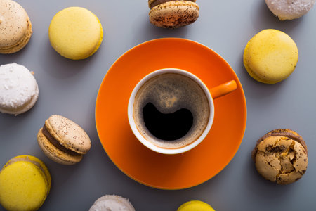 aroma coffee cup with sweet colorful macaroons cake on a table, top viewの写真素材