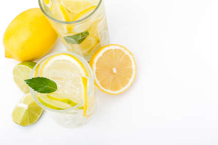 tasty lemonade drink with lemon, lime and mint on wood white table. top viewの写真素材