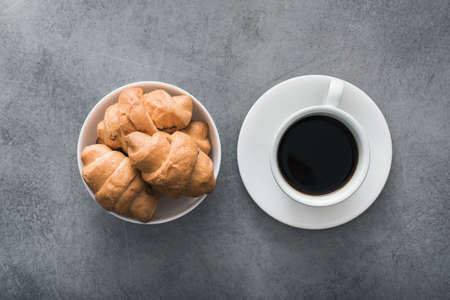 delicious croissant with a cup of coffee, on vintage concrete backgroundの写真素材