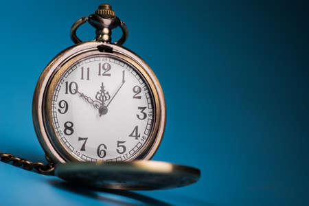 golden retro stopwatch on a blue background. time equipmentの写真素材