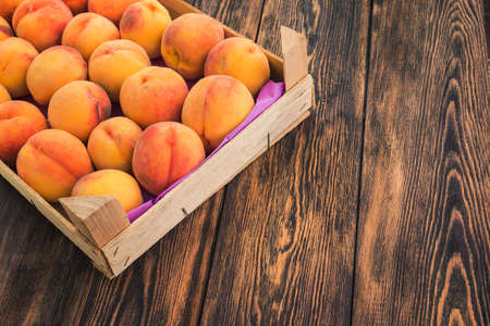 delicious fruit peach at the wood box on tableの写真素材
