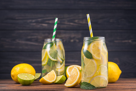Cooling drink lemonade glass with lemon and mint fruit on wooden tableの写真素材