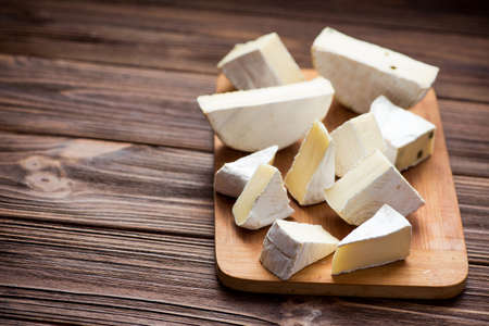 delicious cheese camembert set on wooden board. milk product backgroundの写真素材