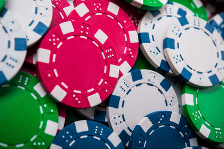 colored poker chips on green casino table. gambling entertainmentの写真素材