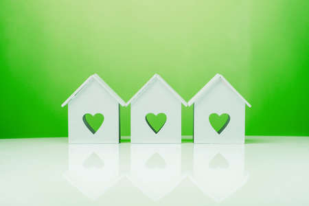 white house model icon with heart symbol on green background. ecological concept at homeの写真素材