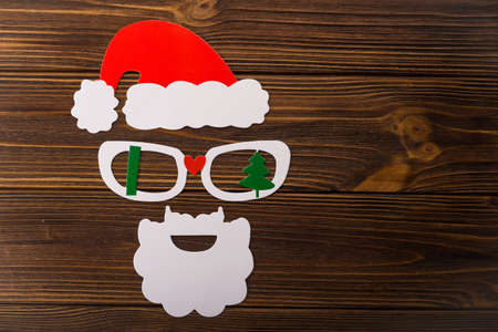 mask of santa claus with photo booth on white background. New Year's concert from the cap, glasses and beardの写真素材