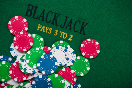 Colored poker chips on green casino table