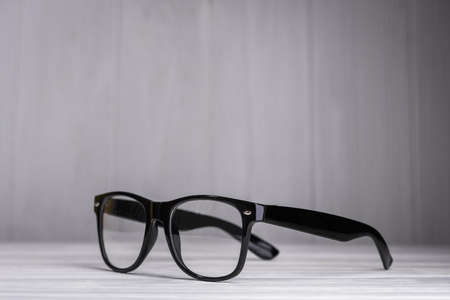 black modern glasses on a wood background, concept about visionの写真素材