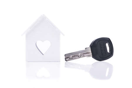 metal key from the house symbol isolated on a white backgroundの写真素材