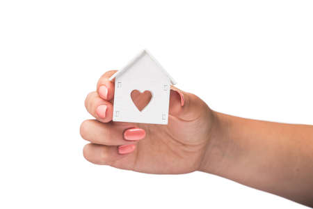woman hold white house model icon with heart symbol isolated on a white backgroundの写真素材