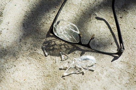 broken glasses on the asphalt. street accident concept. poor eyesight