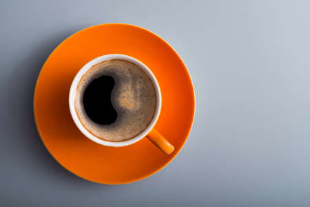 orange aroma coffee cup on a table, top viewの写真素材