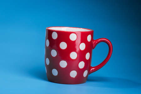 empty red coffee cup on a blue backgroundの写真素材
