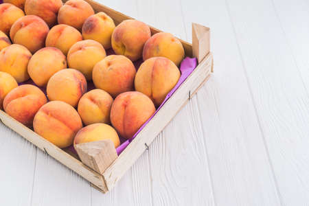 delicious fruit peach at the wood box on tableの写真素材